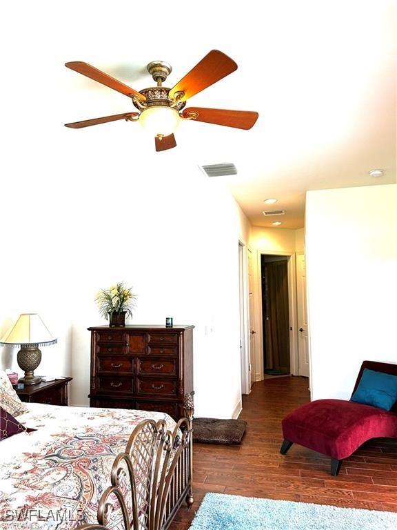 bedroom featuring ceiling fan and dark wood-type flooring