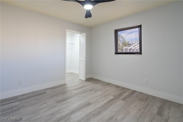 empty room with ceiling fan and light wood-type flooring