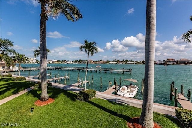 view of dock with a water view and a yard