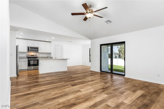 kitchen featuring white cabinets, ceiling fan, appliances with stainless steel finishes, and light hardwood / wood-style flooring