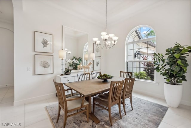 tiled dining space with crown molding, a wealth of natural light, and an inviting chandelier