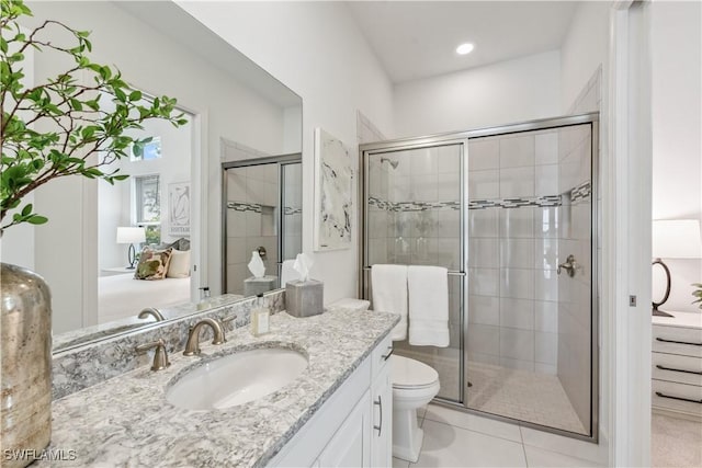 bathroom featuring tile patterned floors, vanity, an enclosed shower, and toilet