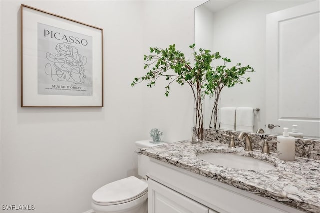 bathroom with vanity and toilet