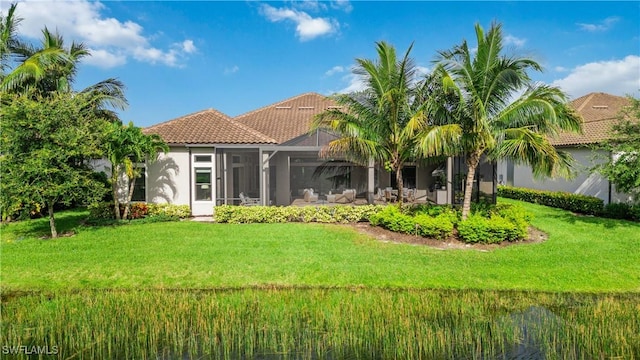 rear view of property with a yard