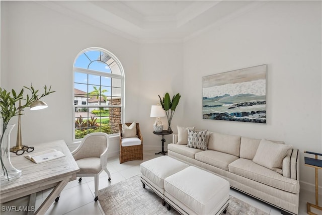 tiled living room featuring ornamental molding and a tray ceiling