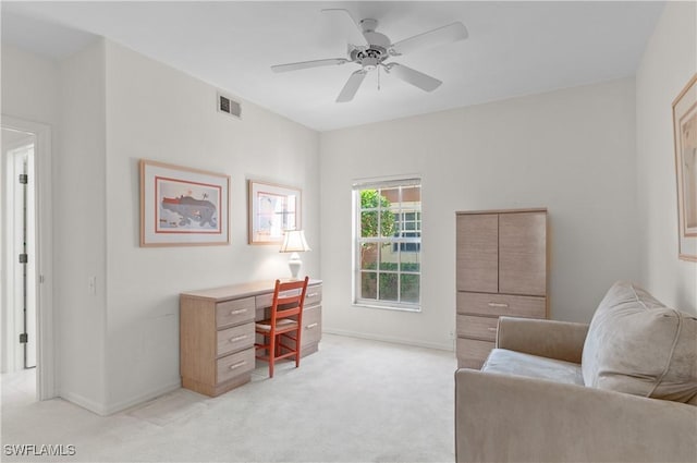 carpeted office space with ceiling fan