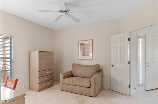 living area with light colored carpet and ceiling fan