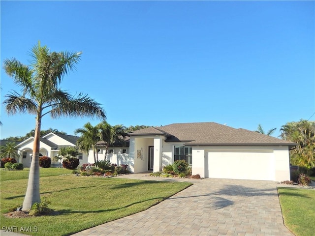 view of front of house with a front lawn and a garage