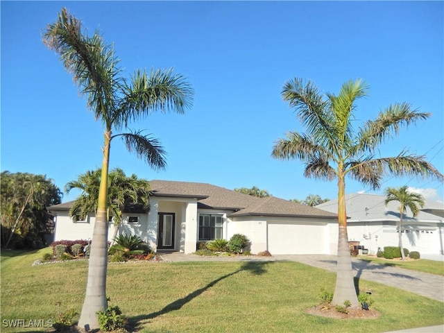 view of front of home with a garage and a front yard