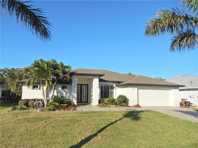 view of front of house with a garage and a front lawn