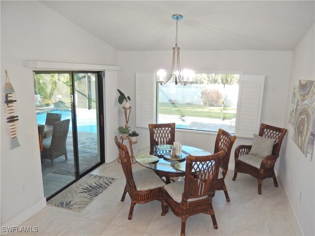 dining space with vaulted ceiling and a chandelier