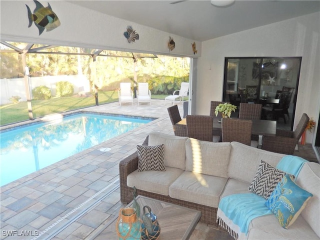 view of swimming pool with a lanai, a patio area, and an outdoor living space