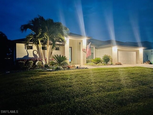 view of front of property with a front lawn and a garage