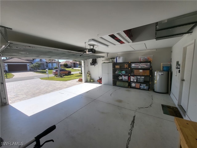 garage with water heater and a garage door opener