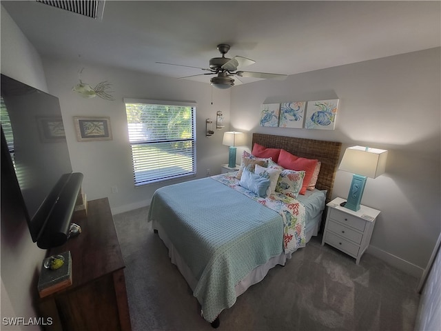 bedroom with dark colored carpet and ceiling fan