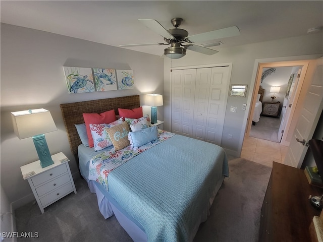 carpeted bedroom with ceiling fan and a closet