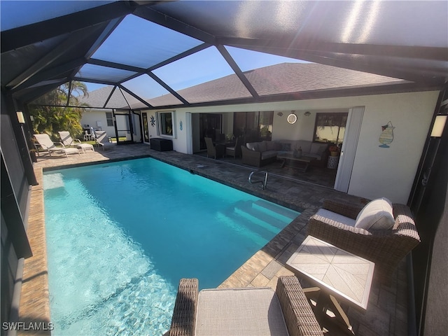 view of pool featuring a lanai, an outdoor living space, and a patio