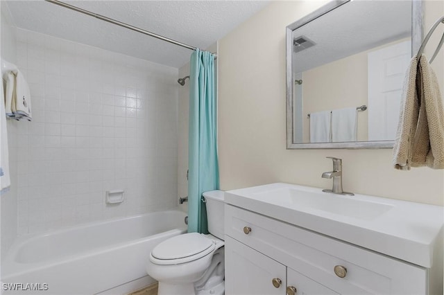 full bathroom with vanity, shower / tub combo with curtain, a textured ceiling, and toilet