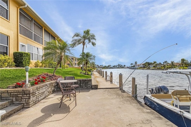 view of patio / terrace featuring a water view and a boat dock