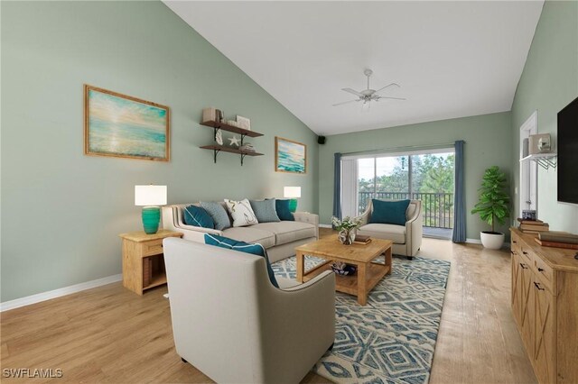 living room with lofted ceiling, ceiling fan, and light wood-type flooring