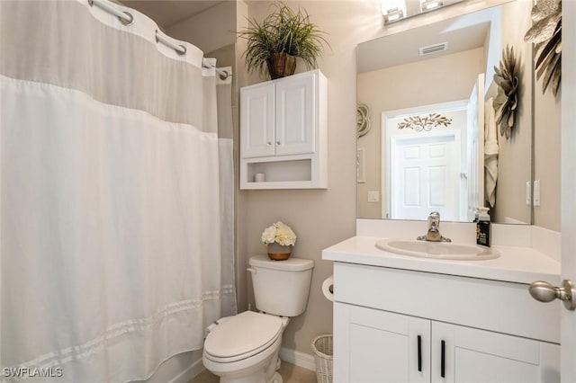 bathroom with vanity, toilet, and curtained shower