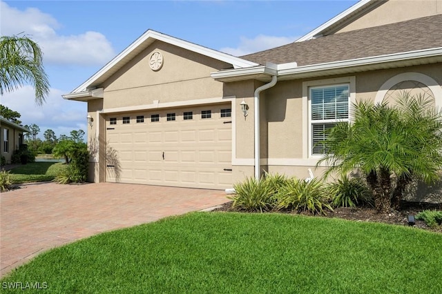 ranch-style house featuring a garage and a front lawn