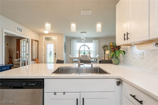 kitchen with white cabinetry, dishwasher, sink, hanging light fixtures, and tasteful backsplash