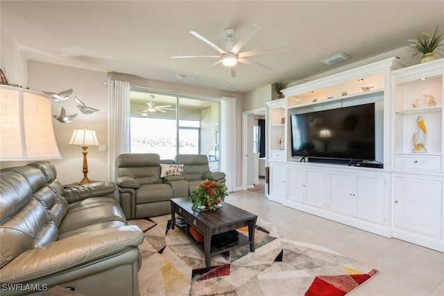 living room featuring ceiling fan and light tile patterned floors