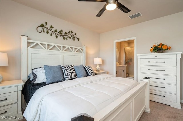 bedroom with connected bathroom, light colored carpet, and ceiling fan