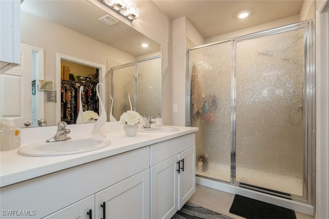 bathroom featuring tile patterned flooring, vanity, and an enclosed shower