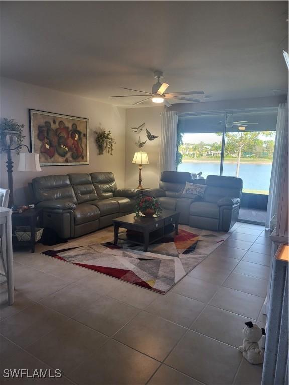 living room featuring tile patterned flooring and ceiling fan