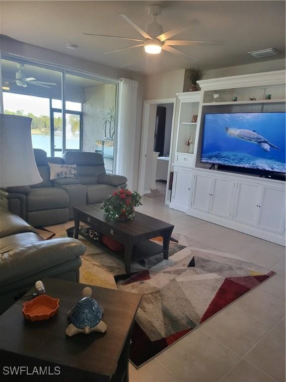 tiled living room featuring ceiling fan