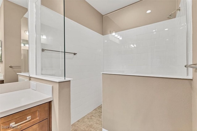 bathroom with walk in shower and vanity