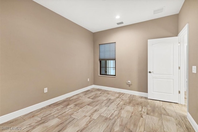 empty room with light hardwood / wood-style flooring