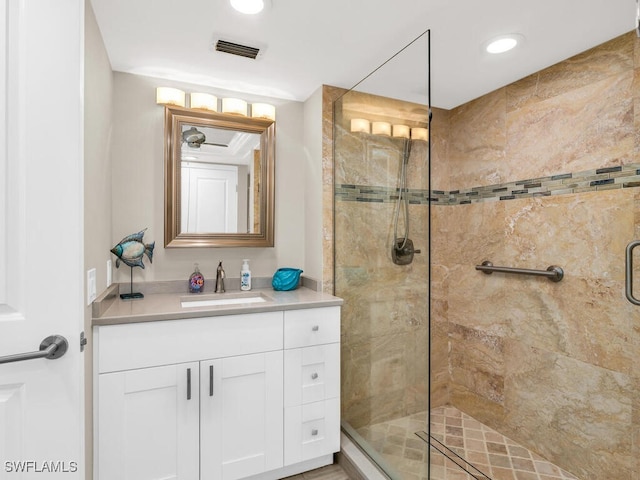 bathroom featuring vanity and an enclosed shower