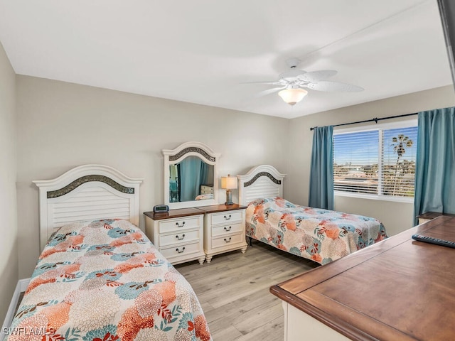 bedroom with light wood-type flooring and ceiling fan