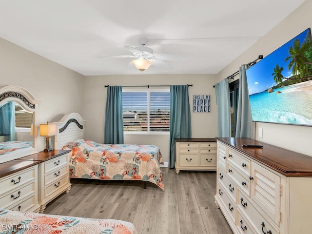 bedroom featuring multiple windows, ceiling fan, and light wood-type flooring