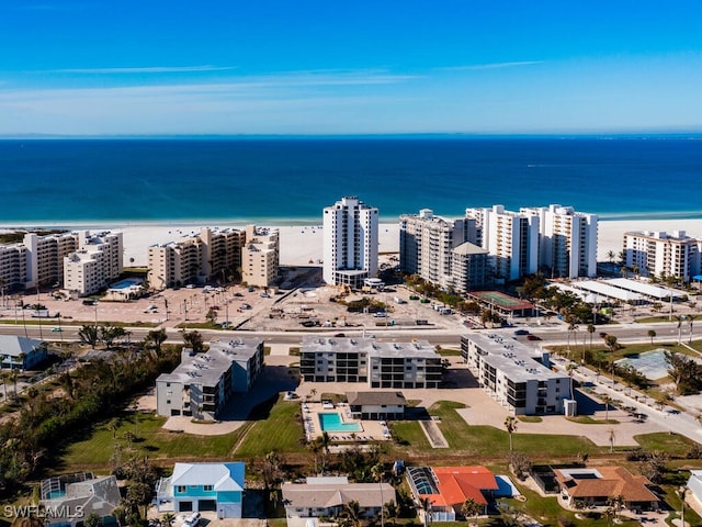 bird's eye view featuring a water view and a beach view