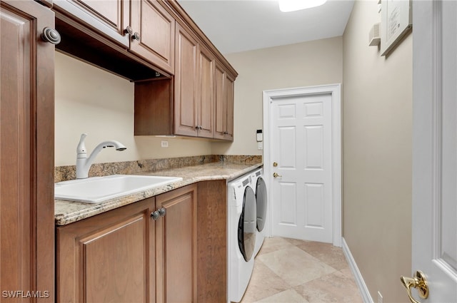 laundry room with cabinets, sink, and washer and dryer