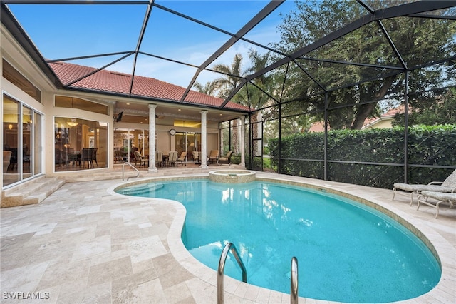 view of swimming pool featuring a lanai, a patio area, and an in ground hot tub