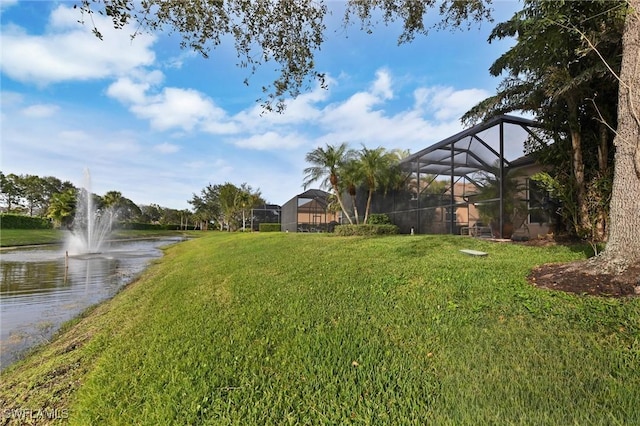 view of yard featuring a lanai and a water view