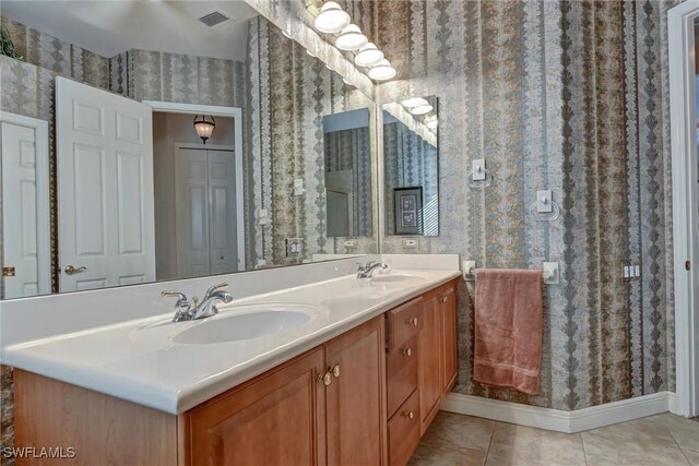 bathroom featuring tile patterned flooring and vanity