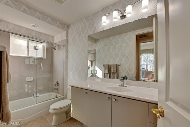 full bathroom with toilet, vanity, tile patterned floors, and enclosed tub / shower combo