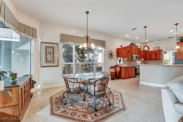 tiled dining area with sink, plenty of natural light, and an inviting chandelier