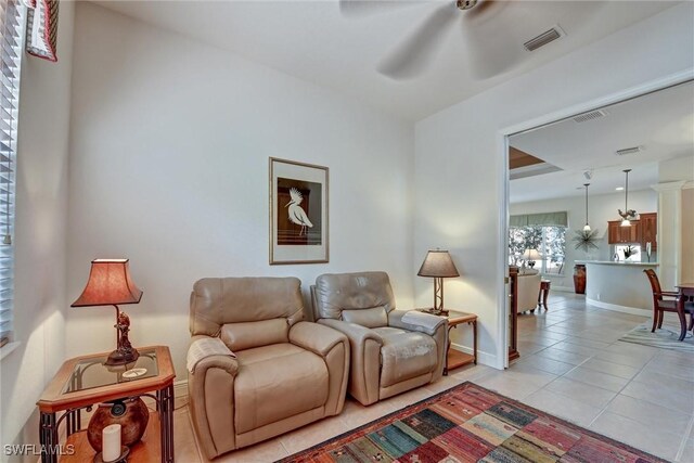 living room featuring light tile patterned floors and ceiling fan