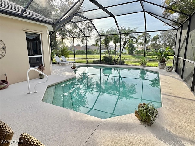 view of swimming pool with a lanai and a patio