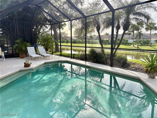 view of swimming pool with a lanai, a patio area, and a water view