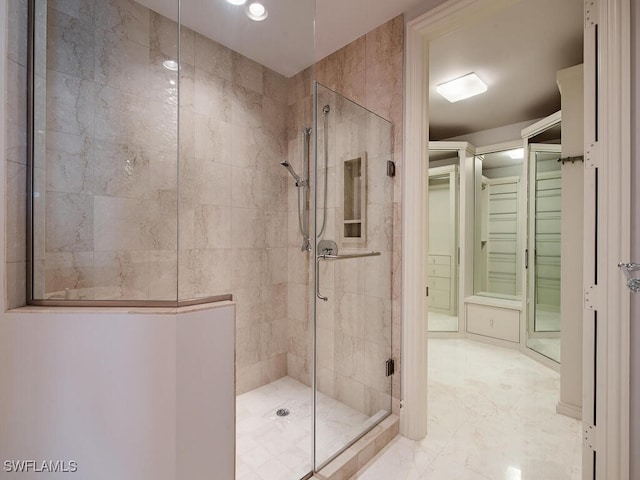 bathroom with an enclosed shower and tile walls