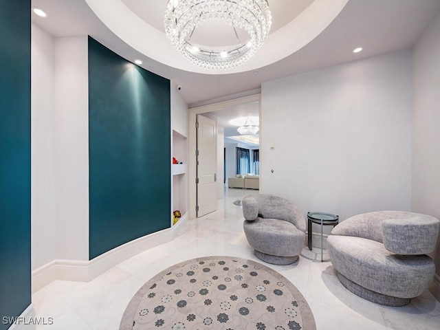 interior space with a notable chandelier and a tray ceiling