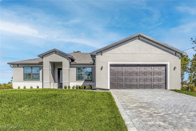 ranch-style house with stucco siding, decorative driveway, an attached garage, a front lawn, and a shingled roof
